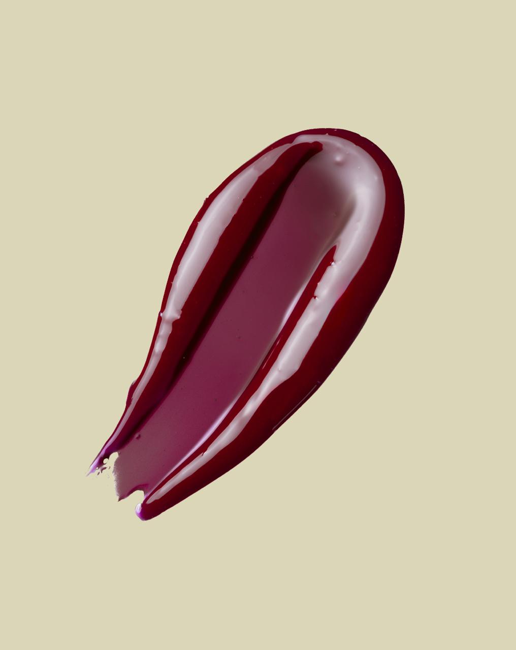 Peptide lip glaze Swatch for smooth, plump lips in shade Deep Berry